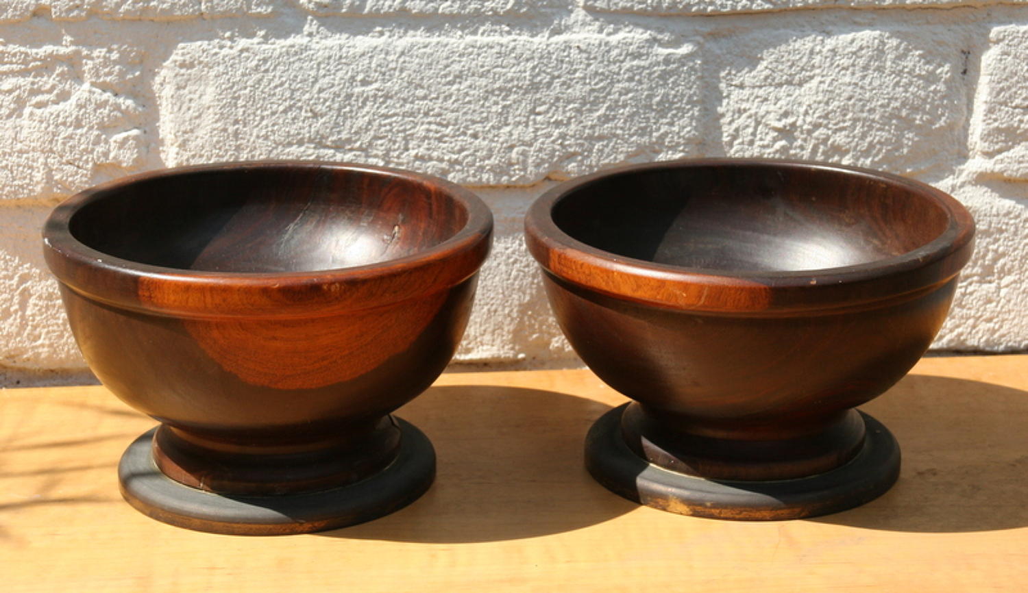 A pair of large Lignum Vitae Bowls on Bronze Stands / foot